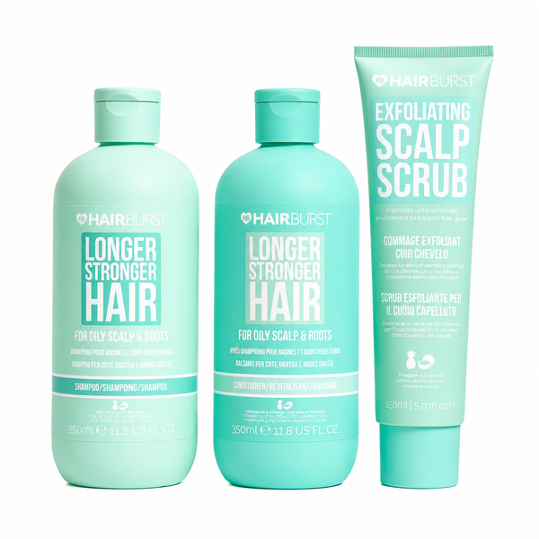 Three HAIRBURST hair care products in mint green packaging on a white background: a Longer Stronger Hair shampoo bottle, a matching conditioner bottle, and an Exfoliating Scalp Scrub tube.