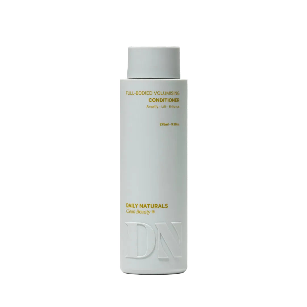 White bottle of Daily Naturals conditioner on a light gray background