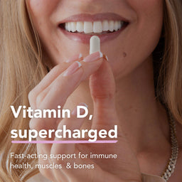 Close-up of a smiling woman holding a white vitamin supplement capsule near her mouth, with text reading 'Vitamin D, supercharged' and 'Fast-acting support for immune health, muscles & bones'.