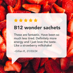 A promotional graphic with a white speech-bubble style card over a background of sliced red strawberries. The card reads 'B12 wonder sachets' with five yellow stars and a customer review quote by Gillian R.