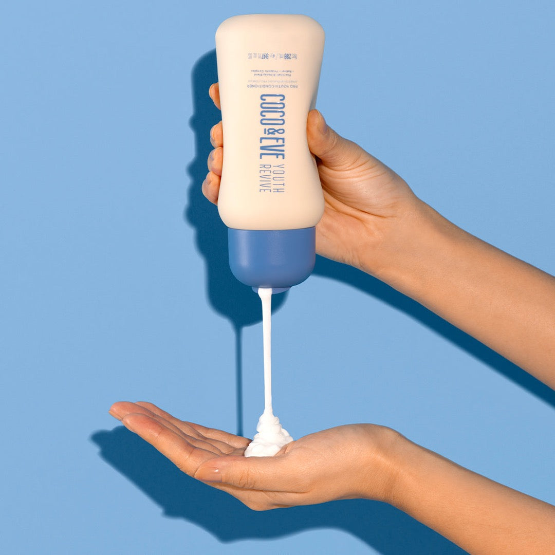 Coco & Eve Youth Revive Pro Youth Conditioner being poured into a hand