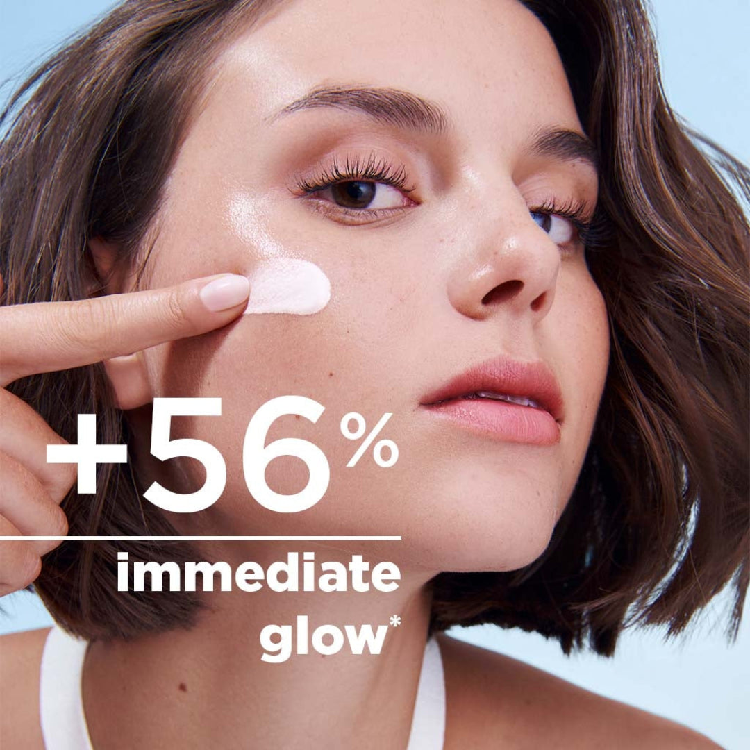 Woman applying cream to her face with text indicating +56% immediate glow