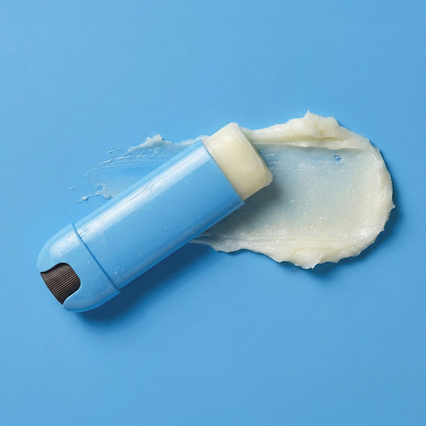 Blue lip balm with white cream on a blue background