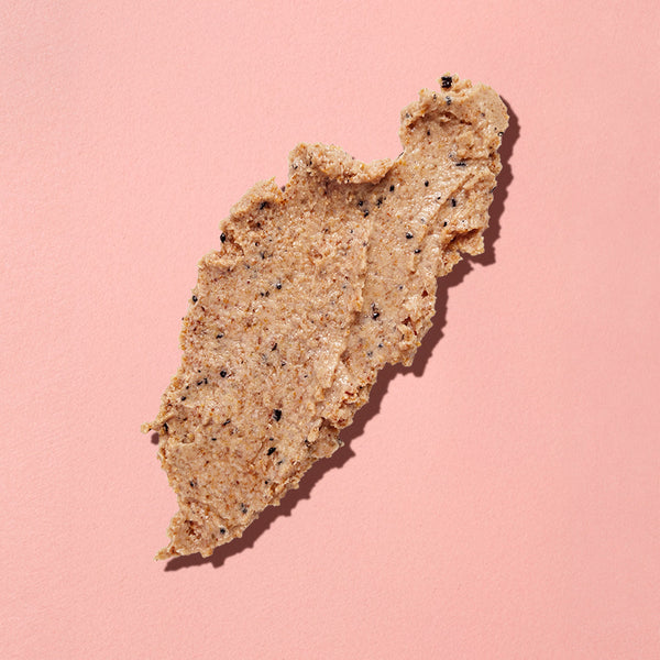 Brown leaf-shaped substance on a pink background