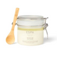 Jar of ESPA salt scrub with a wooden spoon on a white background