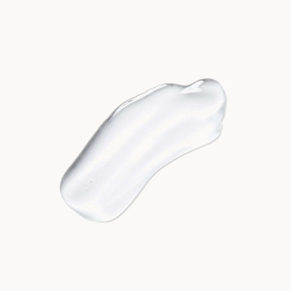 A glossy, translucent smear of clear cosmetic gel or serum on a solid off-white background.
