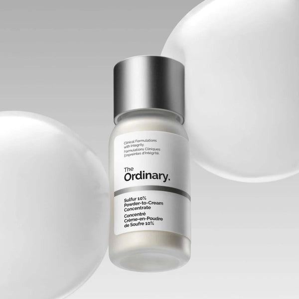 Skincare serum bottle labeled 'The Ordinary' on a gray background