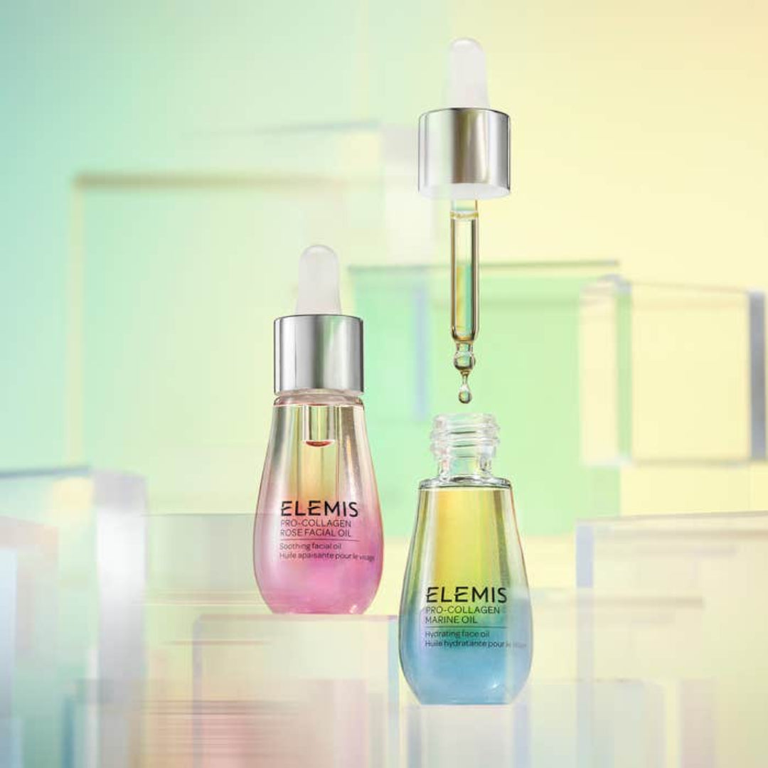 Two Elemis skincare bottles with a dropper on a colorful background