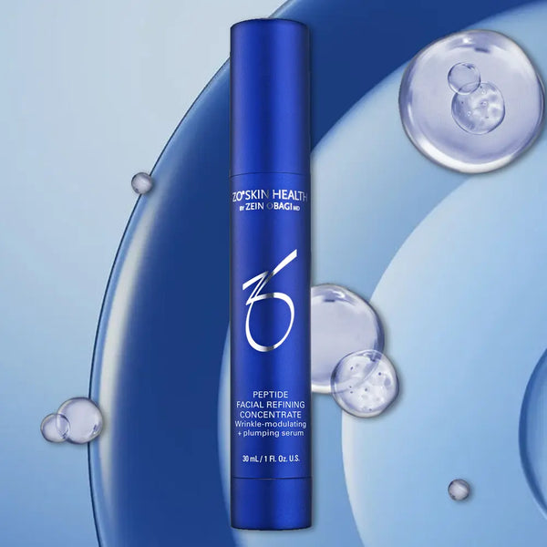 Blue skincare serum bottle with 'ZO Skin Health' branding on a blue background with water droplets.