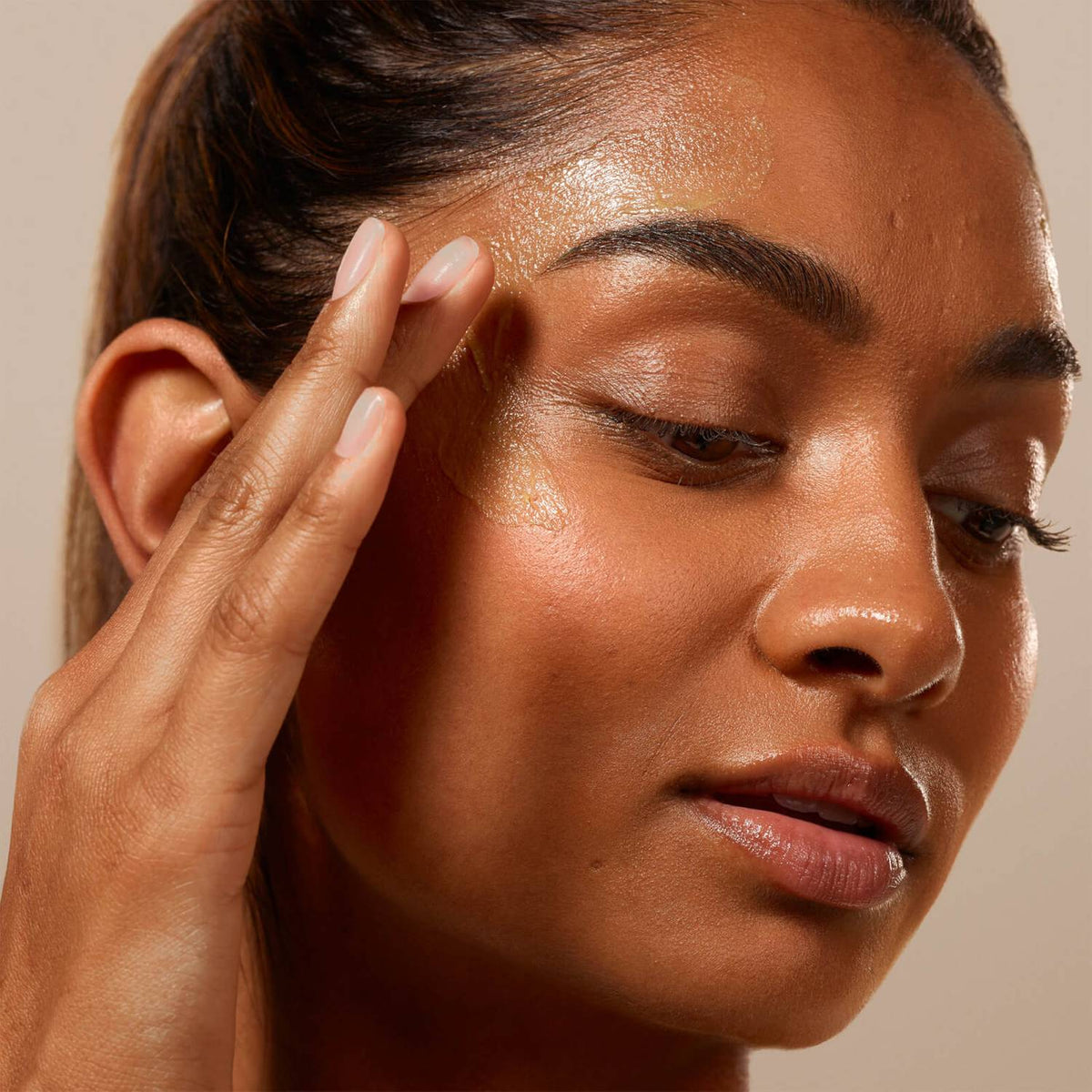 a women applying the balm to her face
