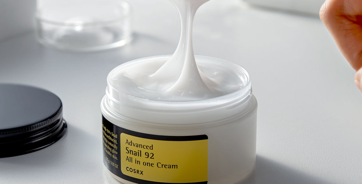 Model dipping their fingers into COSRX Advanced Snail 92 All in one Cream