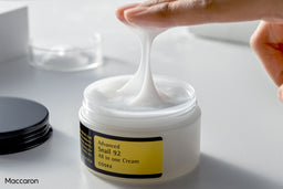 Model dipping their fingers into COSRX Advanced Snail 92 All in one Cream