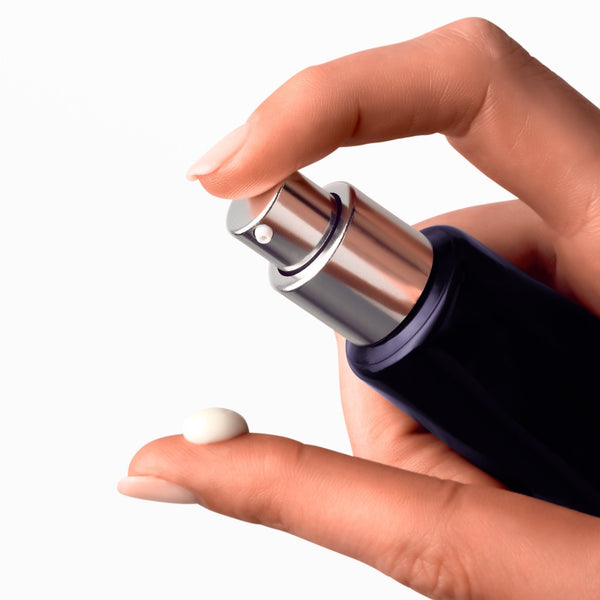 A model placing a drop of serum on their finger