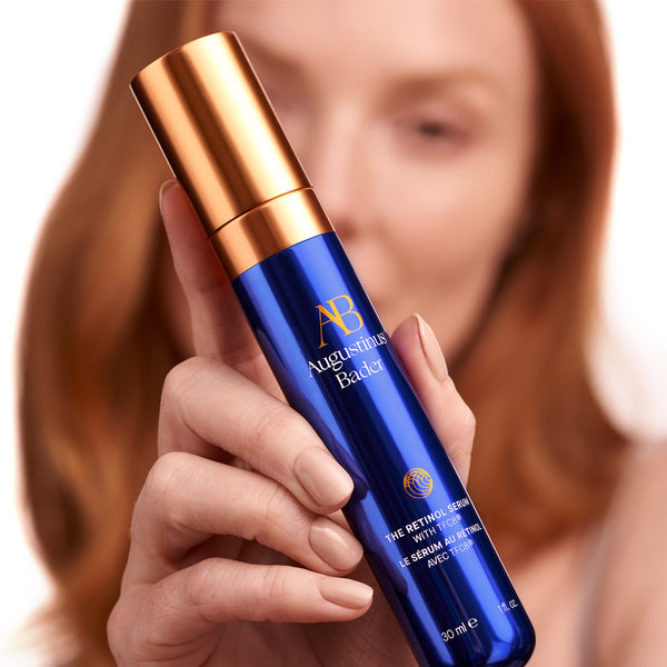 Model holding Augustinus Bader The Retinol Serum 30ml