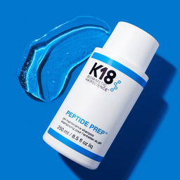 K18 PEPTIDE PREP pH Maintenance Shampoo with a spread of shampoo next to the bottle