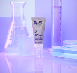 Retinol eye cream tube inside a purple coloured lab